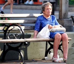 a woman sat on a bench alone.