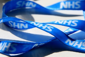 a blue ribbon with white lettering saying NHS NHS NHS