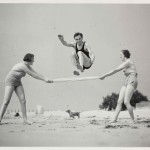 a black and white photo of 2 women and a man exercising on a beach