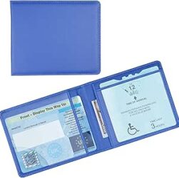 Blue Badge Scheme. Image shows a blue parking permit in a blue holder. The holder has two sides and the permit is in one side and the time indicator the other
