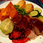 A plate containing a traditional roast dinner