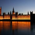 a picture of the houses of parliament lit up at night