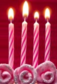 four pink birthday cake candles