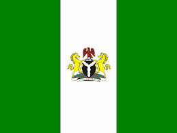 this image shows the nigerian flag witha green vertical stripe each side and an logo with two unicorns in the middle.