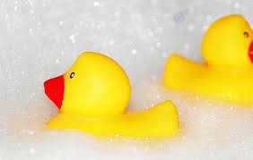 this image shows bath bubbles with 2 rubber ducks in them