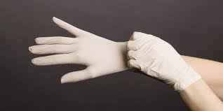 this image shows a pair of hands with surgical latex gloves on