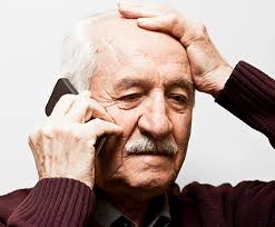 this image shows an elderly man using a mobile phone