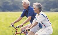 this image shows two older adults cycling 
