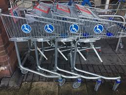this image shows a row of Tesco trolley for use with a wheelchair
