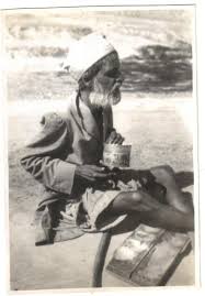 this image shows an elderly indian man begging