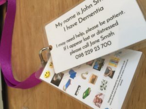 this image shows the dementia assistance card on a purple lanyard with a micro communication card behind it for people who are unable to speak