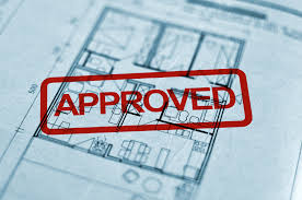this image shows plans and the ink stamp "approved" on it.