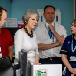 This image shows the Prime Minister Mrs May and NHS staff in a hospital ward