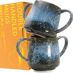 This image shows two beautiful mottled blue stoneware mugs with two handles on each