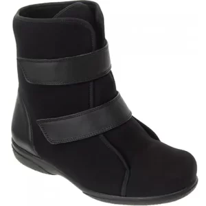 This article is called "Footwear For Someone Who Has Had A Stroke". This image shows an ankle boot that is black. It has a flat rubber sole and a slightly elevated heel. The boot is mid calf height and has two velcro straps to fasten. 