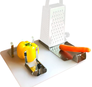This image shows the one handed cutting board with a yellow bell pepper secured in place with adjustable steel plates. It also shows a white cheese grater and a carrot.