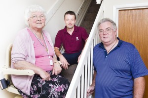 an elderly woman and her son and a stairlift