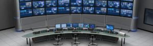 this image shows a control room full of monitors