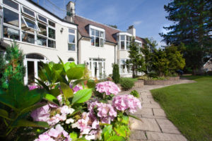 This image shows an award winning care home in Manchester. Dystlegh Grange, is housed in a former golf club house.