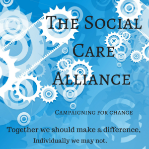 this image is of a sign. It has a blue background and white cogs. The Words say " The social care alliance" campaigning for change, together we should make a difference, individually we may not