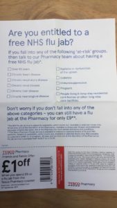 This image shows a photo of a leaflet advertising free flu jabs from Tesco