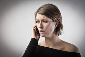this image shows a young lady on her mobile looking worried